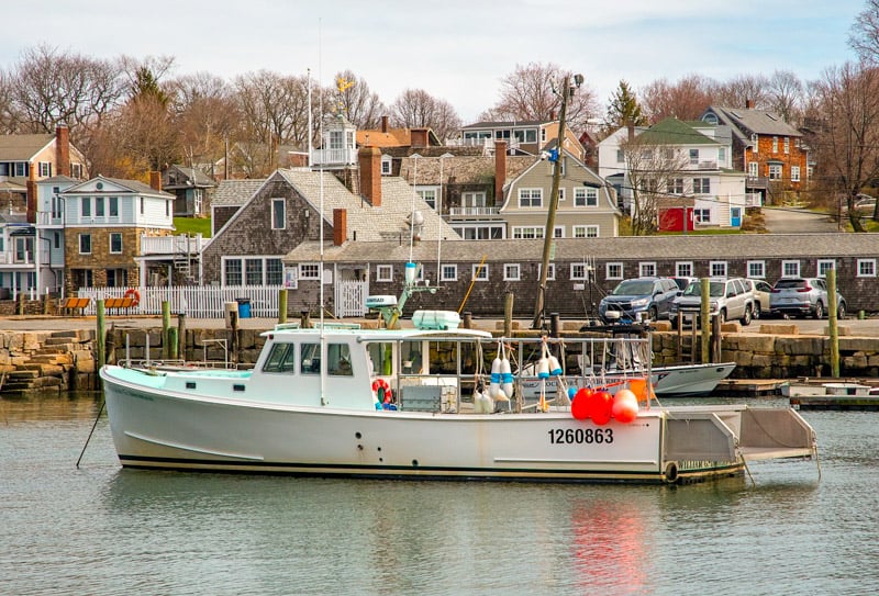 A boat resting on the waters of Rockport, one of the smaller New England cities to visit