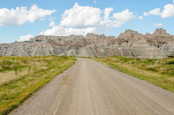 Dirt road cutting through the dramatic Badlands terrain in South Dakota