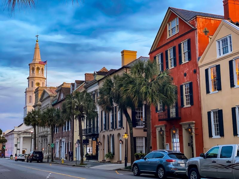 Historic street in Charleston, South Carolina with colorful houses and cobblestone pavement