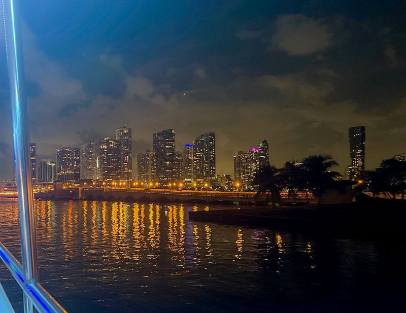Sail on Biscayne Bay for a mesmerizing view of the city's skyline at night, reflecting on calm waters.