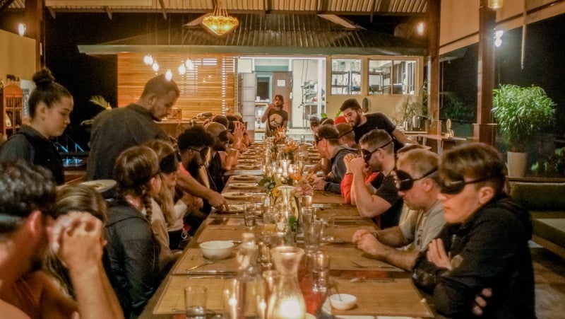 Dining in the dark is a bucket list experience where you eat a meal without seeing what you're eating