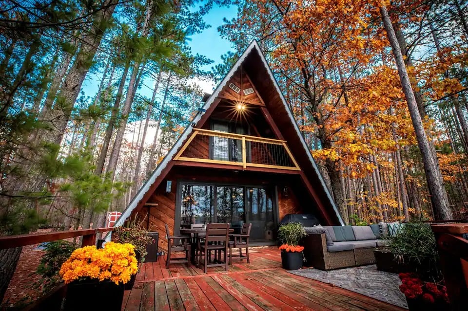This cozy A-frame cabin is one of the best fall foliage Airbnbs in the US, offering stunning autumn views and a perfect woodland escape