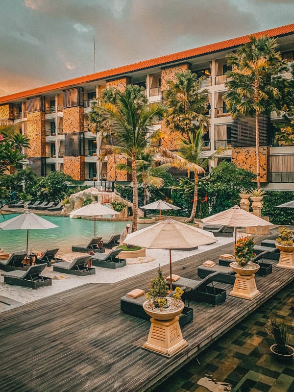 A serene pool area with comfortable lounge chairs and umbrellas