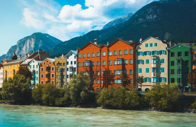 Embrace the mountains and city buzz in Innsbruck, where snowy peaks frame a vibrant urban scene.