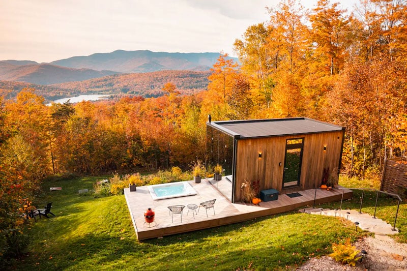 Luxury Glass Tiny House offers a unique stay in the Green Mountains with panoramic fall views and immersive nature.