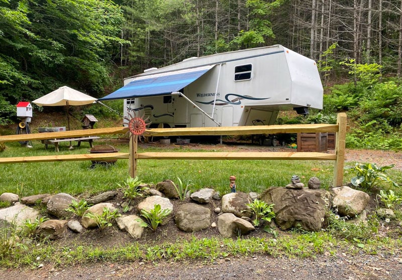 Mapleleaf Hideaway is an upgraded camper with a fire pit, picnic table, and hiking trail for a relaxing escape.