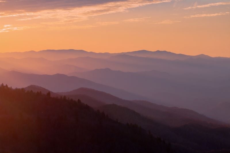 A stunning view of the Smoky Mountains with a vibrant sunset in the background