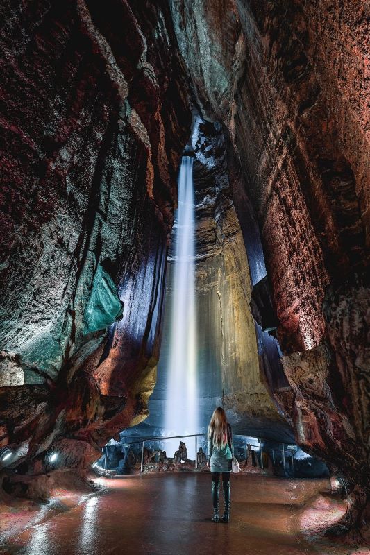 A cave explorer admiring the captivating Ruby Falls and its unique rock formations