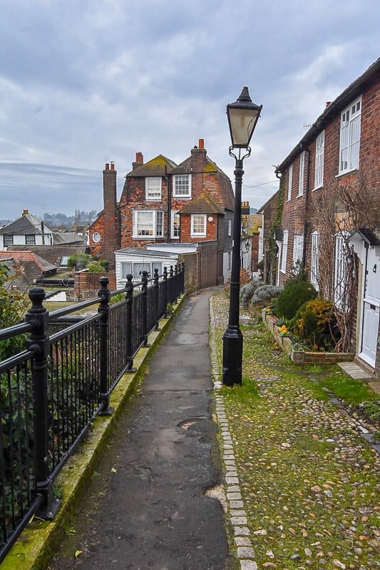 A charming narrow street with a lamp post and a fence in Rye