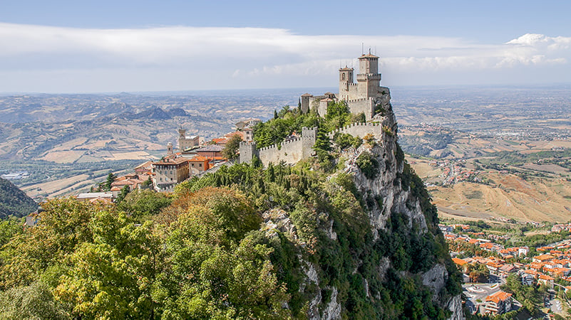 Castle atop mountain, surveying scenic valley landscape in Italian Peninsula, San Marino