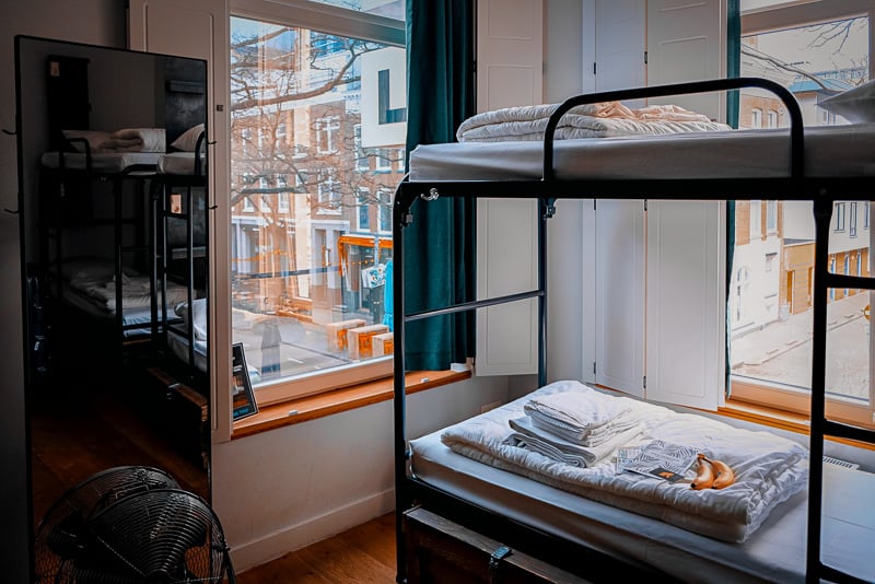 Thinking about how to save money while traveling? Stay at a hostel.