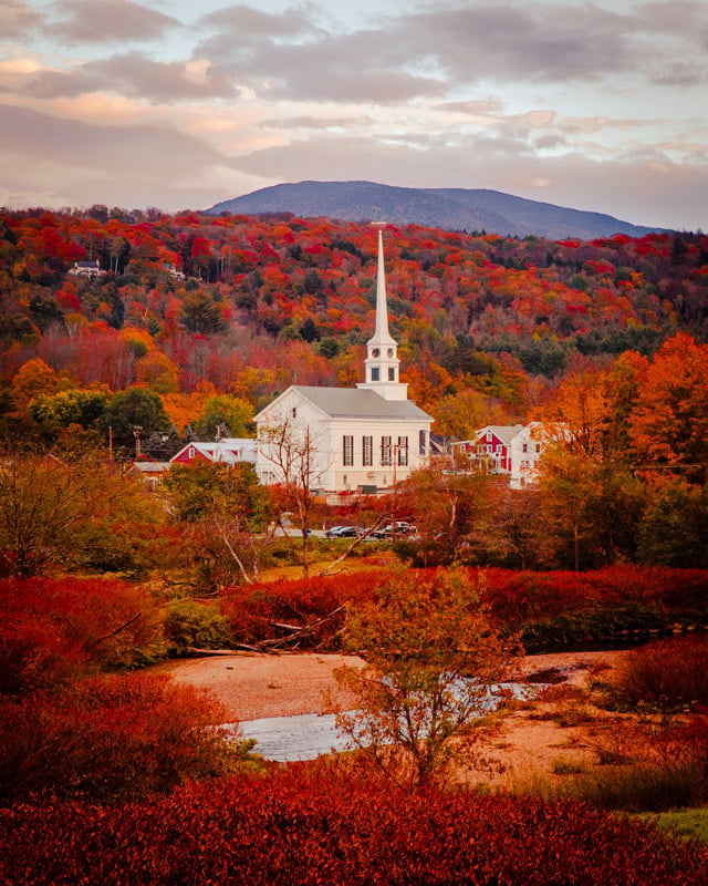 A picturesque church surrounded by vibrant fall foliage