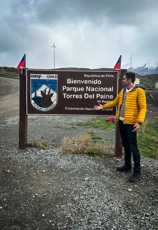 Me standing in front of Torres del Paine sign