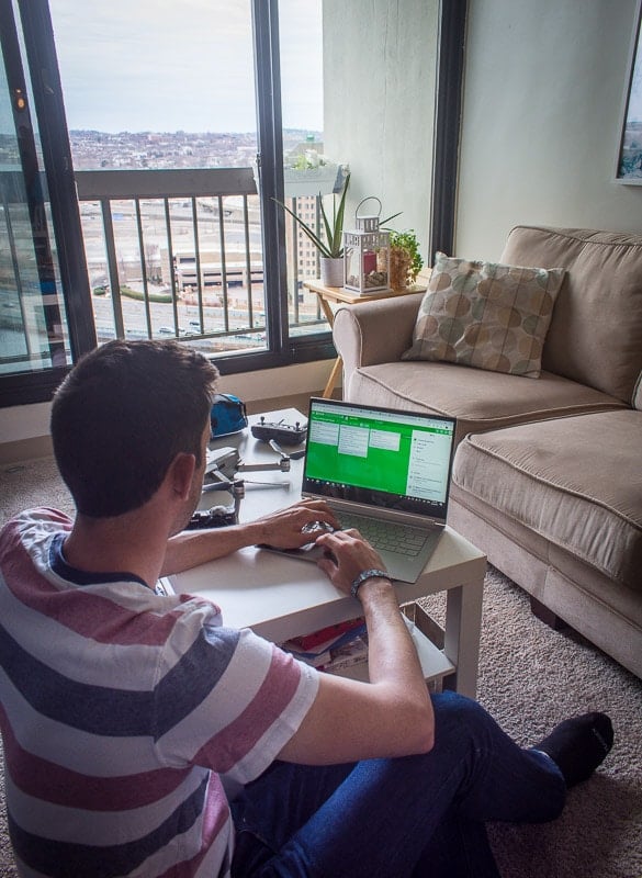 Jon focused on his work, sitting in front of a laptop computer, typing diligently.