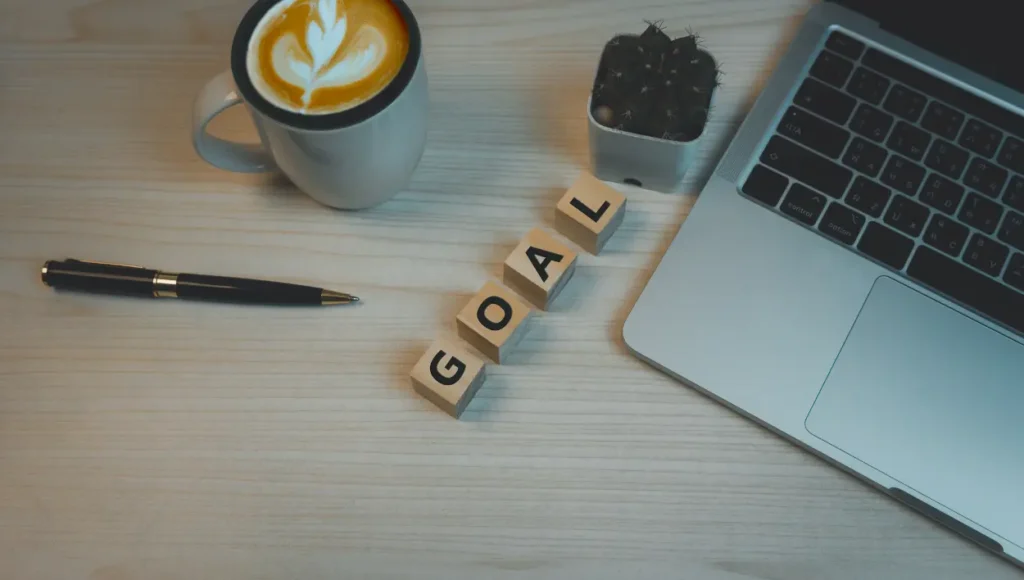 A word "Goal" on a wooden block